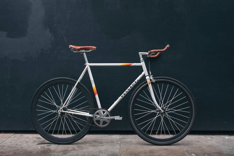 Vélos de ville alignés devant un mur clair